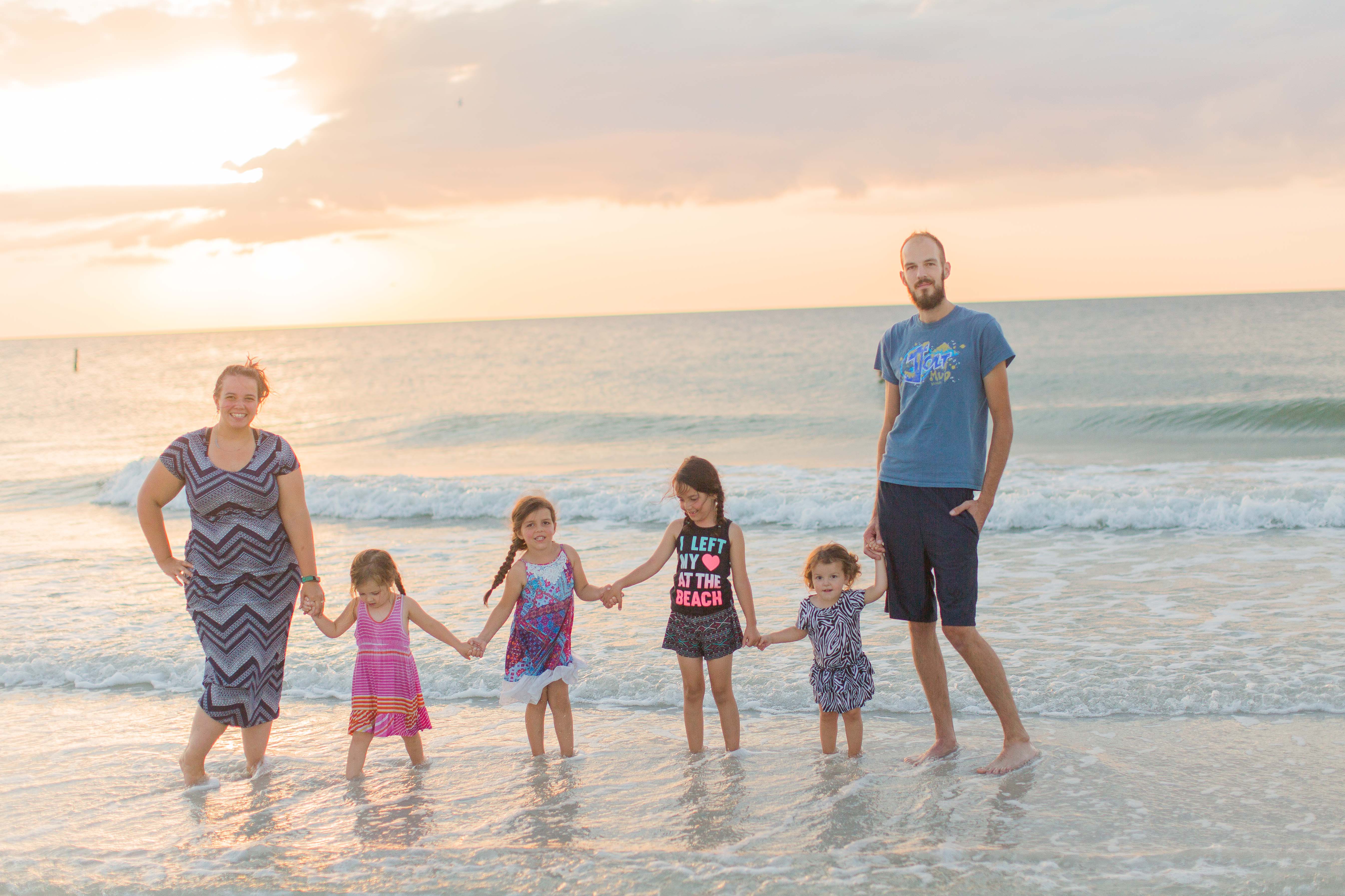 family at sunset on the beach